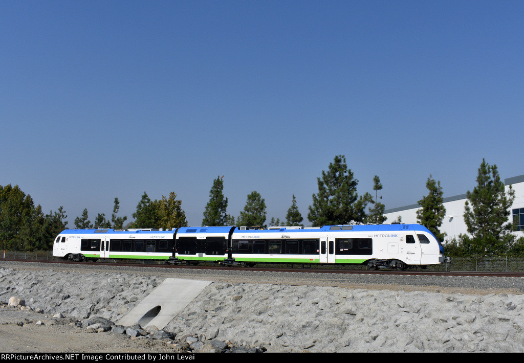 Eastbound bound for Redlands-University Station heading along The Mission Zanja after crossing Mountain View Avenue at grade